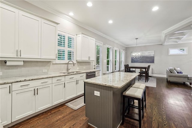 2585 Drew Valley Rd NE, Brookhaven, GA 30319 - kitchen with dark wood-style flooring, a chandelier, a breakfast bar area, recessed lighting, and backsplash