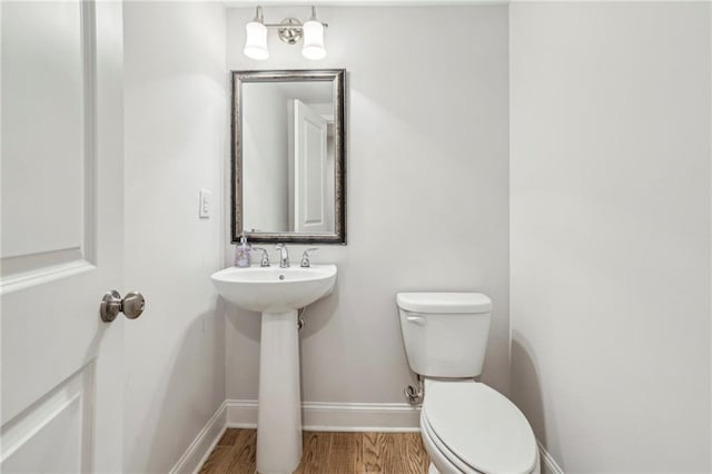 2585 Drew Valley Rd NE, Brookhaven, GA 30319 - half bathroom featuring toilet, baseboards, and wood finished floors