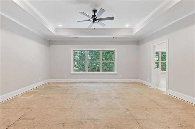 unfurnished room with a tray ceiling, ornamental molding, and ceiling fan