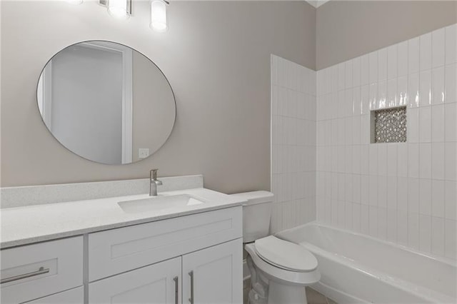 full bathroom with vanity, tiled shower / bath combo, and toilet