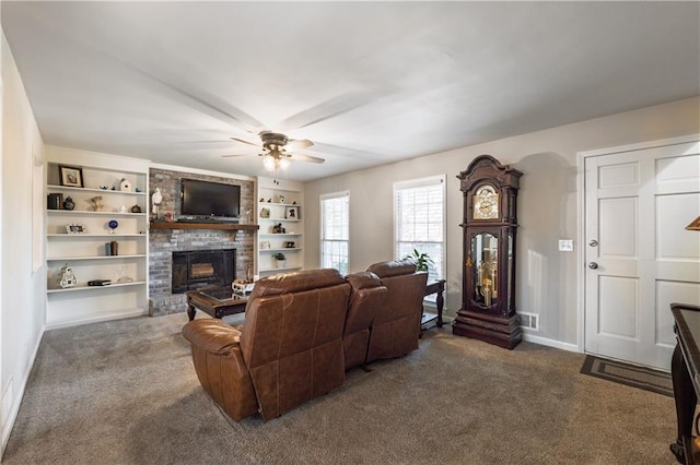 carpeted living area featuring visible vents, a ceiling fan, built in features, a fireplace, and baseboards