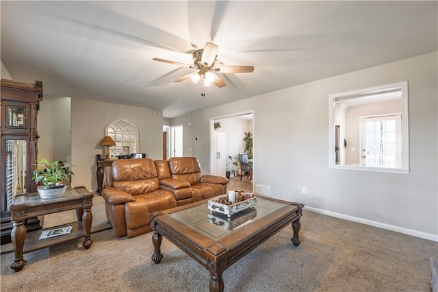 living area with ceiling fan, visible vents, baseboards, and light carpet