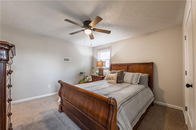 carpeted bedroom featuring visible vents, baseboards, a textured ceiling, and ceiling fan