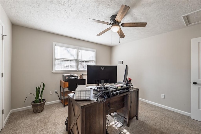 office space with visible vents, baseboards, light colored carpet, and ceiling fan