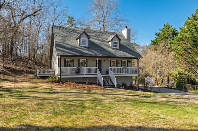 view of front of home with a porch, a chimney, stairs, and a front lawn