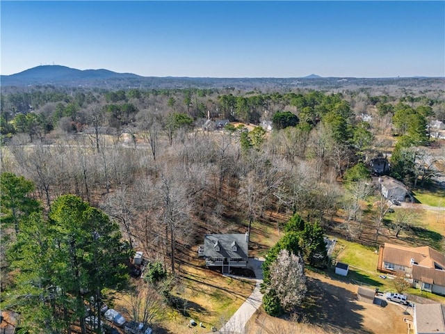 drone / aerial view with a mountain view and a forest view