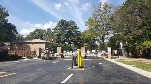 4701 Flat Shoals Rd Unit 68D, Union City, GA 30291 - view of asphalt street featuring a gate, a gated entry, street lighting, and curbs