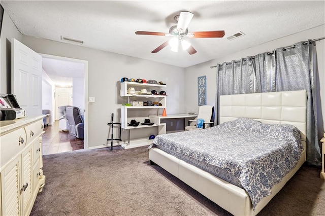 bedroom with ceiling fan and dark carpet