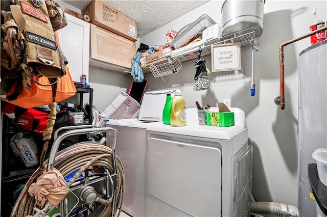 washroom with washing machine and dryer and a textured ceiling