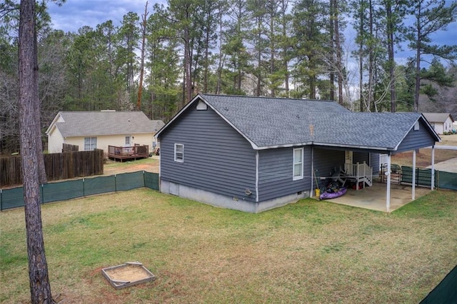 exterior space with crawl space, a lawn, roof with shingles, and fence