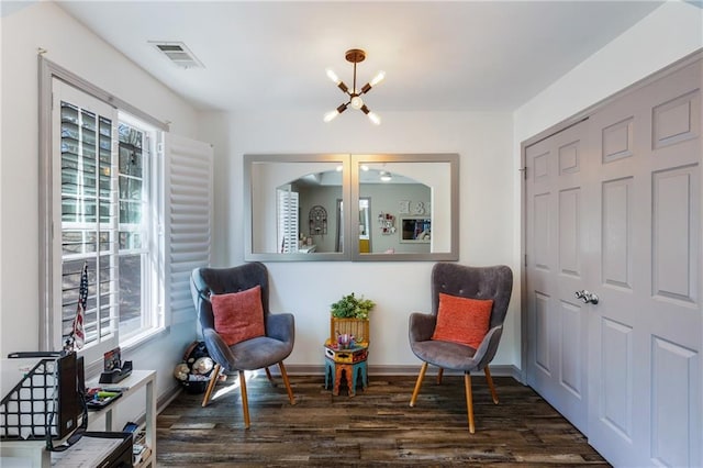 sitting room with wood finished floors, visible vents, plenty of natural light, and a chandelier