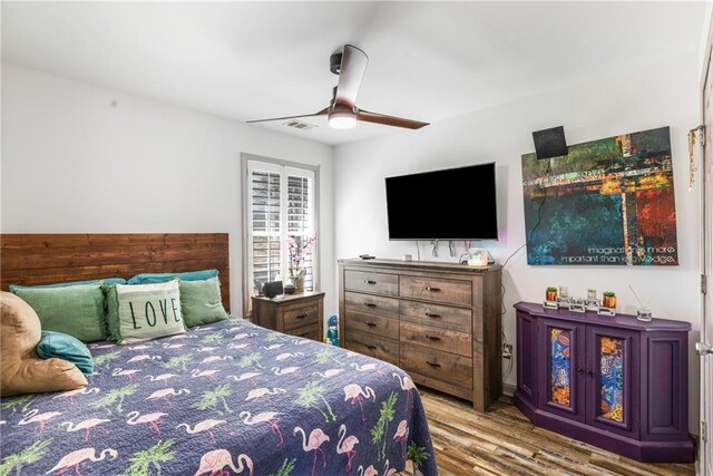 bedroom with ceiling fan and wood finished floors