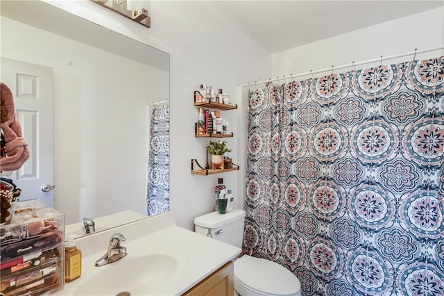 bathroom with vanity, a shower with shower curtain, and toilet