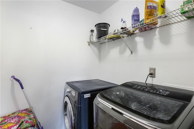 washroom featuring washer and dryer and laundry area