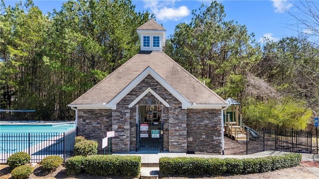 exterior space with a community pool and fence