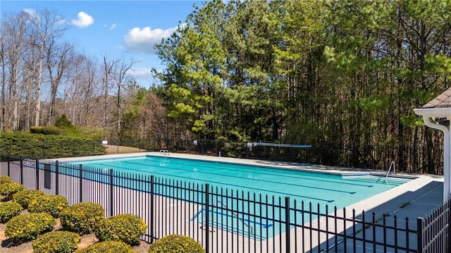 pool with a patio and fence