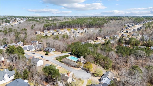 drone / aerial view with a wooded view