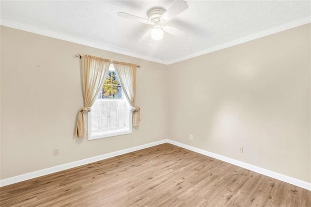 unfurnished room with ceiling fan, baseboards, wood finished floors, and ornamental molding