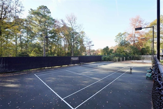 view of tennis court with fence