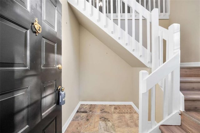 interior space featuring baseboards and stairs