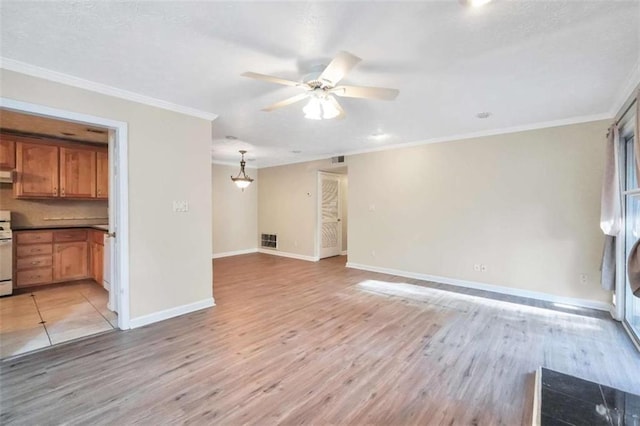 unfurnished living room with a ceiling fan, crown molding, light wood-style flooring, and baseboards