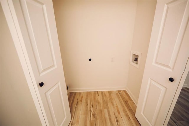 laundry area with hookup for an electric dryer, washer hookup, and light hardwood / wood-style flooring