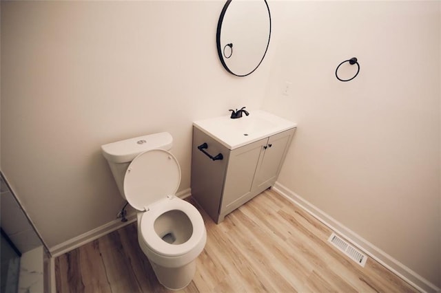 bathroom featuring hardwood / wood-style floors, vanity, and toilet