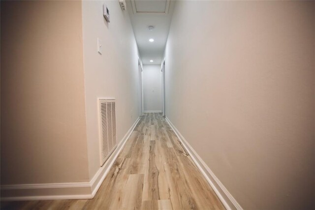 hallway with light hardwood / wood-style flooring