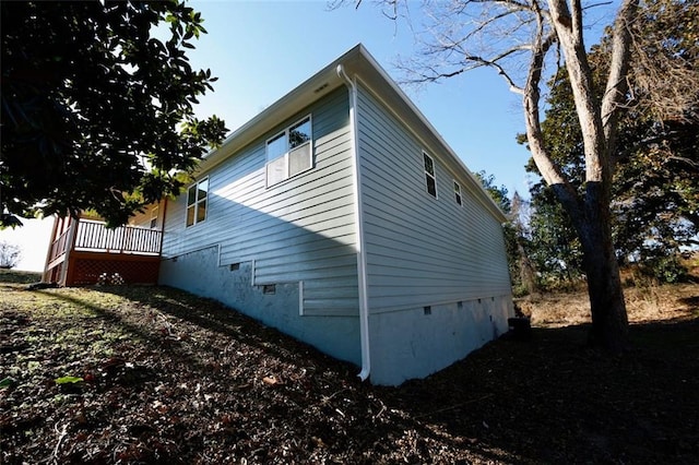 view of home's exterior featuring a wooden deck