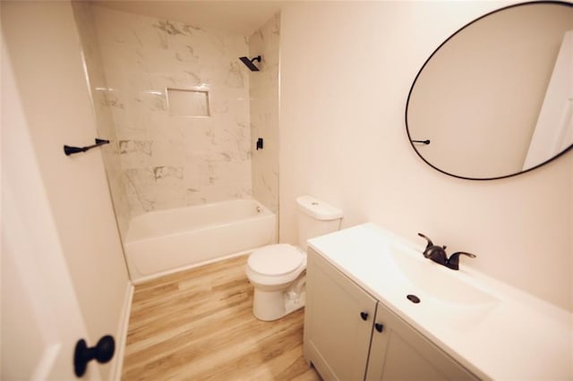 full bathroom with vanity, toilet, wood-type flooring, and tiled shower / bath