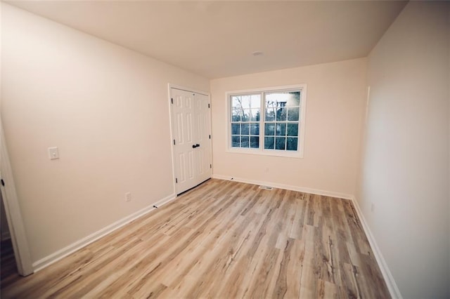 spare room with light hardwood / wood-style floors