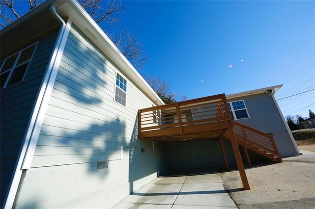 back of house featuring a wooden deck