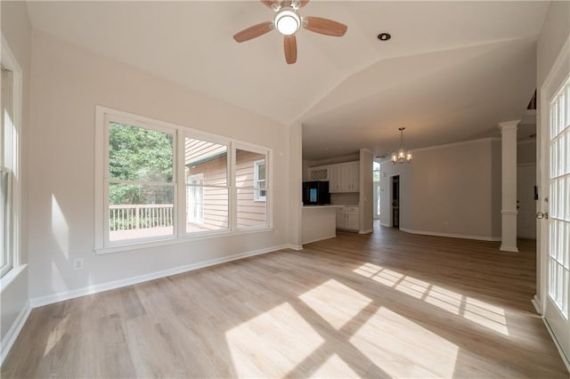 4495 Riders Ridge Trl, Snellville, GA 30039 - unfurnished living room featuring vaulted ceiling, light wood-style floors, ceiling fan, a chandelier, and ornate columns