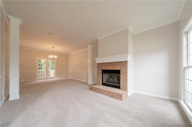 4495 Riders Ridge Trl, Snellville, GA 30039 - unfurnished living room featuring a chandelier, a brick fireplace, carpet, ornamental molding, and baseboards