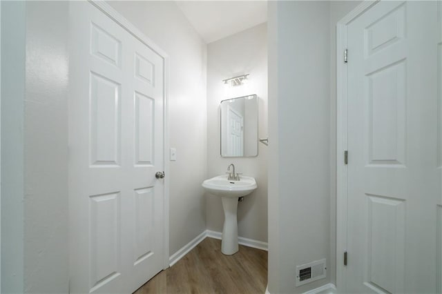 4495 Riders Ridge Trl, Snellville, GA 30039 - bathroom featuring wood finished floors, baseboards, and a sink