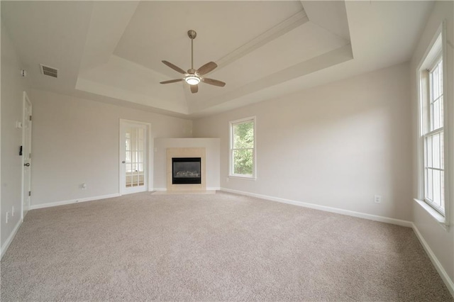 4495 Riders Ridge Trl, Snellville, GA 30039 - unfurnished living room featuring a raised ceiling, ceiling fan, baseboards, and carpet flooring