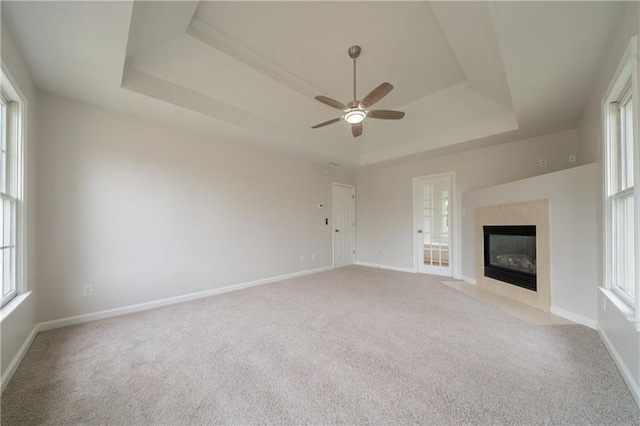 4495 Riders Ridge Trl, Snellville, GA 30039 - unfurnished living room with a tray ceiling, light carpet, and ceiling fan