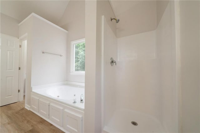 4495 Riders Ridge Trl, Snellville, GA 30039 - bathroom featuring a shower, a whirlpool tub, wood finished floors, and vaulted ceiling