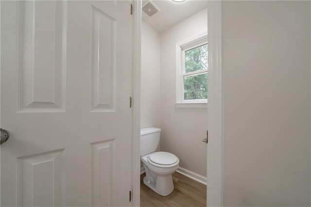 4495 Riders Ridge Trl, Snellville, GA 30039 - bathroom with wood finished floors, toilet, and baseboards