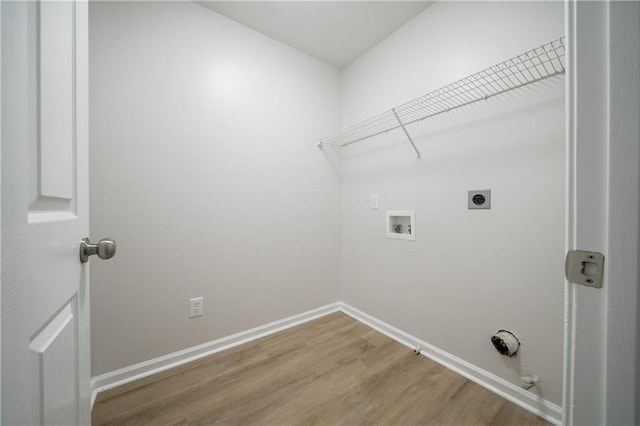 4495 Riders Ridge Trl, Snellville, GA 30039 - laundry area with hookup for a washing machine, wood finished floors, electric dryer hookup, hookup for a gas dryer, and baseboards