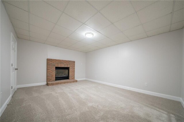 4495 Riders Ridge Trl, Snellville, GA 30039 - unfurnished living room featuring light colored carpet, a paneled ceiling, baseboards, and a fireplace