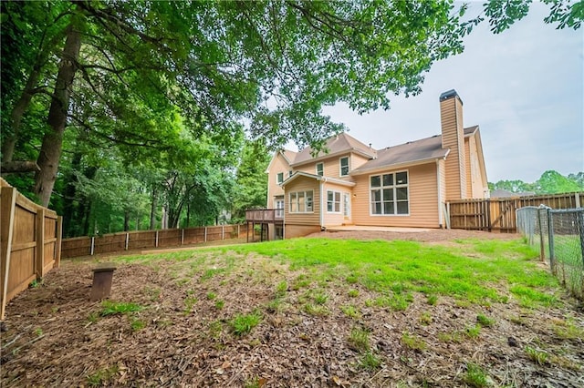 4495 Riders Ridge Trl, Snellville, GA 30039 - rear view of house featuring a chimney and a wooden deck