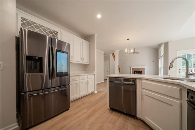 4495 Riders Ridge Trl, Snellville, GA 30039 - kitchen featuring appliances with stainless steel finishes, a sink, white cabinets, a chandelier, and recessed lighting