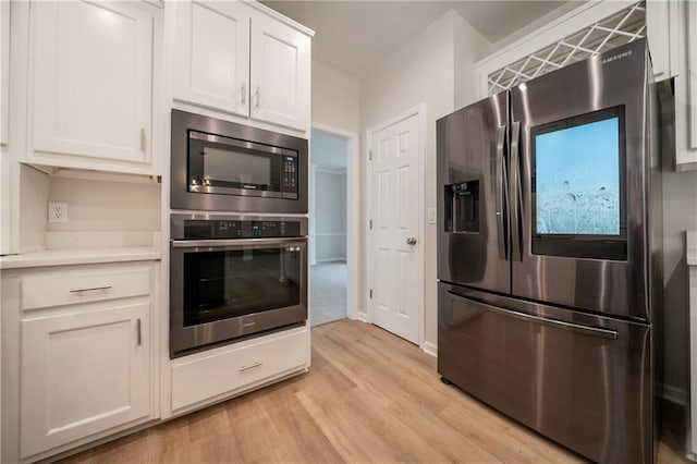 4495 Riders Ridge Trl, Snellville, GA 30039 - kitchen featuring stainless steel appliances, light wood-style flooring, white cabinets, and light countertops