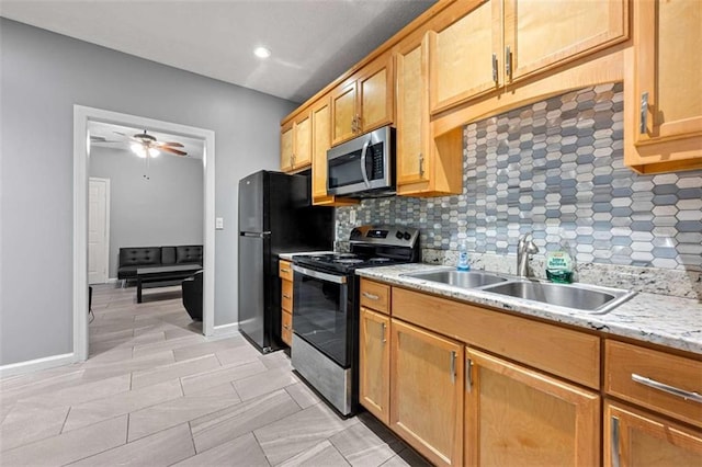650 Ira St SW, Atlanta, GA 30312 - kitchen featuring a ceiling fan, a sink, backsplash, and stainless steel appliances