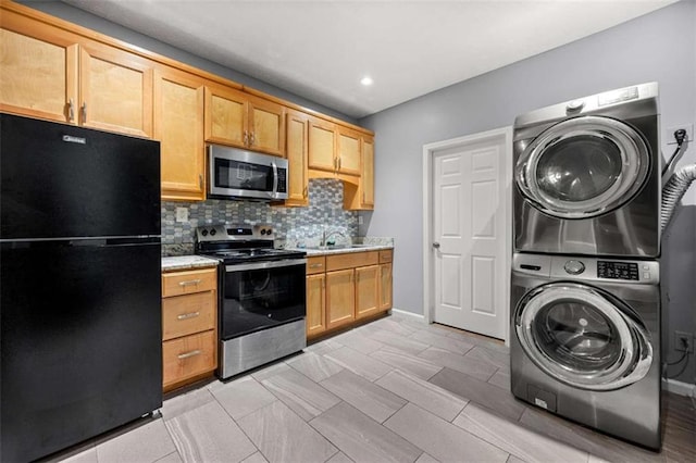 650 Ira St SW, Atlanta, GA 30312 - kitchen with stacked washer and dryer, light countertops, appliances with stainless steel finishes, and a sink