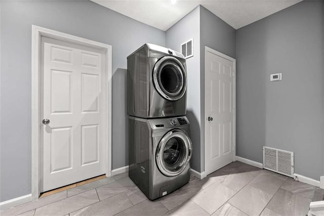 650 Ira St SW, Atlanta, GA 30312 - clothes washing area featuring visible vents, baseboards, stacked washer / dryer, and laundry area