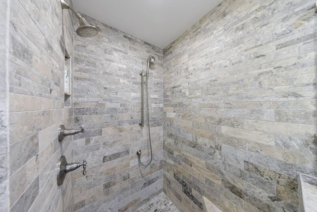 interior details featuring a tile shower