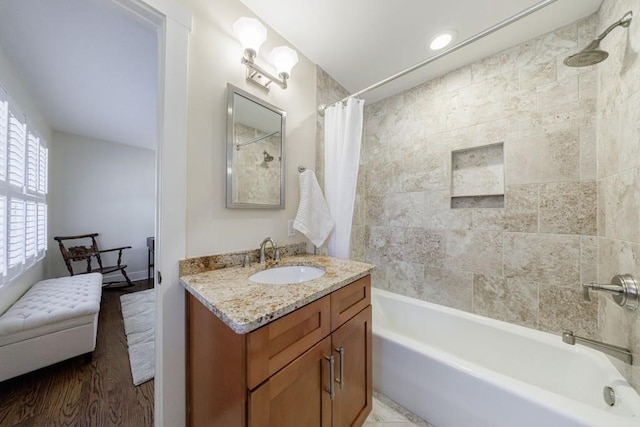 bathroom featuring shower / tub combo, wood finished floors, and vanity