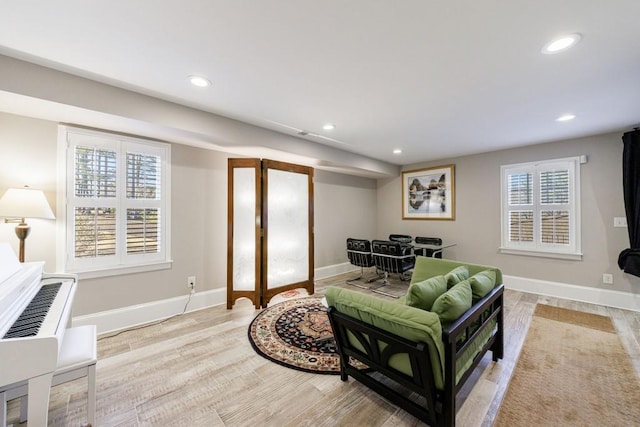 living room featuring wood finished floors, a wealth of natural light, and recessed lighting